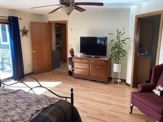 bedroom featuring ceiling fan, light wood finished floors, and access to exterior