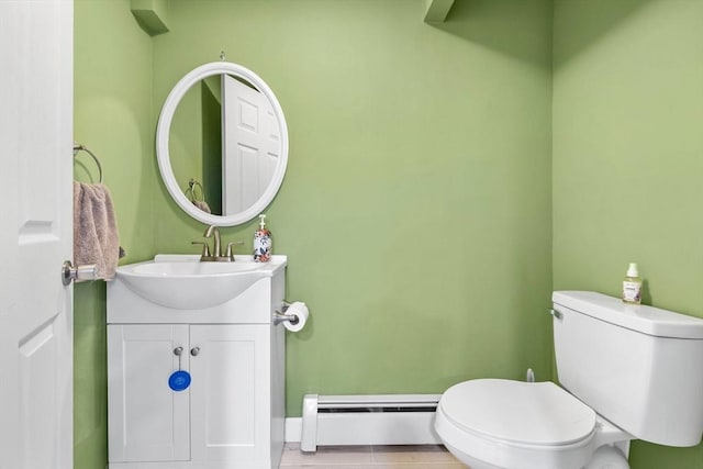 bathroom featuring a baseboard radiator, toilet, and vanity