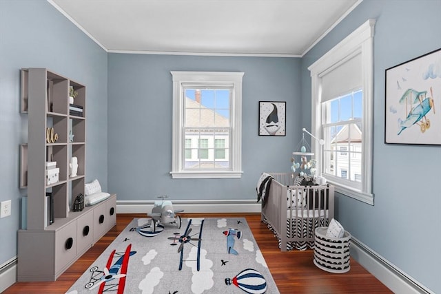 game room featuring dark wood-type flooring, crown molding, and plenty of natural light