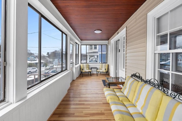 sunroom / solarium featuring wood ceiling