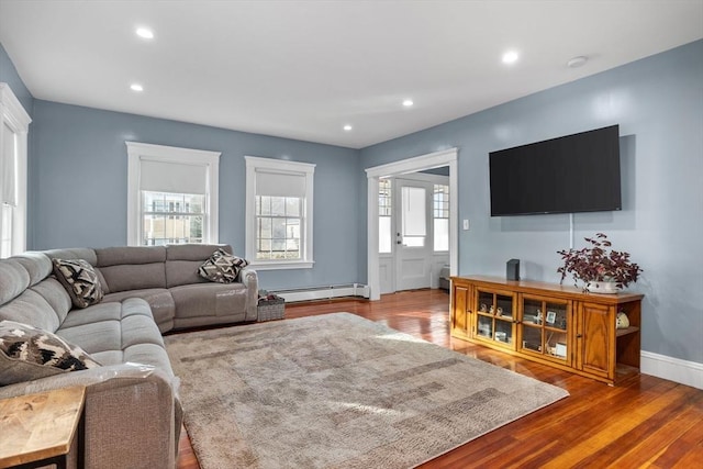 living room featuring a baseboard radiator and wood-type flooring