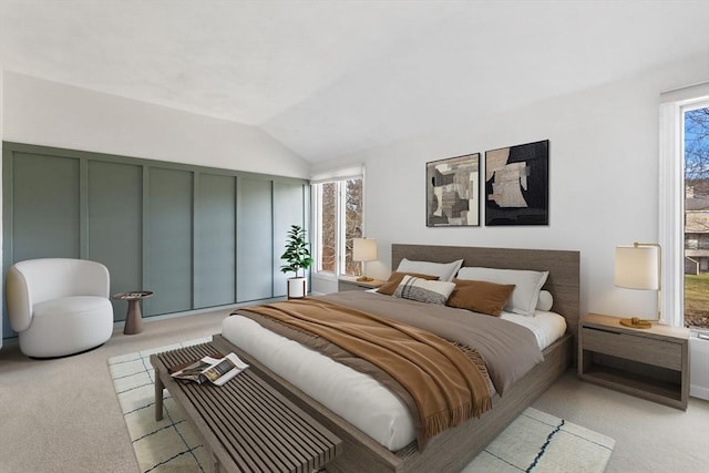 bedroom with light carpet and lofted ceiling