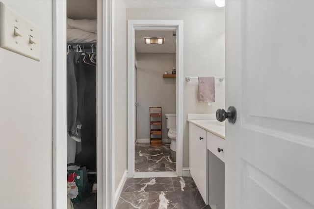 bathroom featuring vanity and toilet