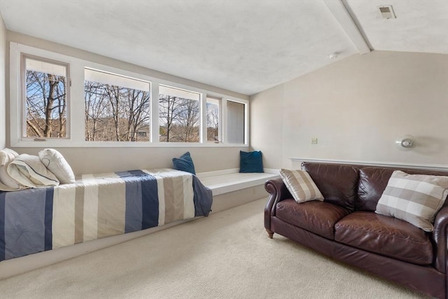 bedroom with light colored carpet and lofted ceiling with beams