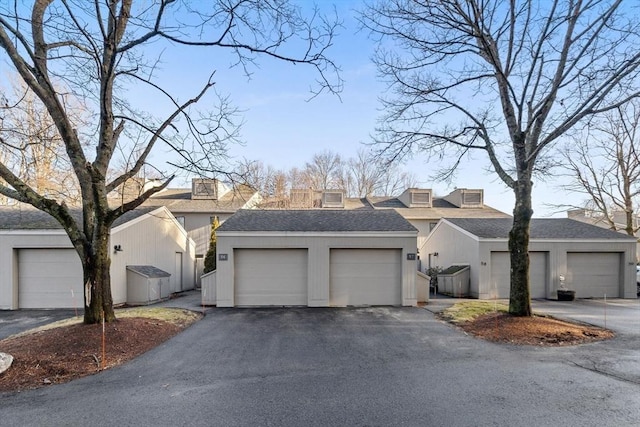 view of front facade featuring a garage and an outdoor structure