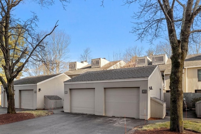 exterior space featuring a garage and an outdoor structure