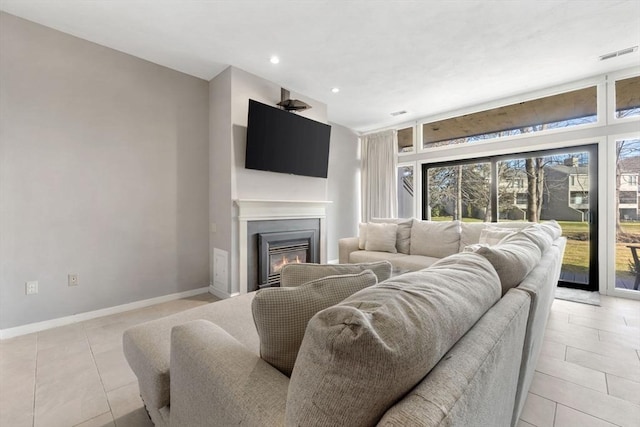 living room with ceiling fan and light tile patterned floors