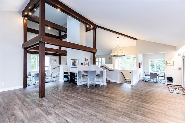 kitchen with pendant lighting, dark hardwood / wood-style flooring, and an inviting chandelier