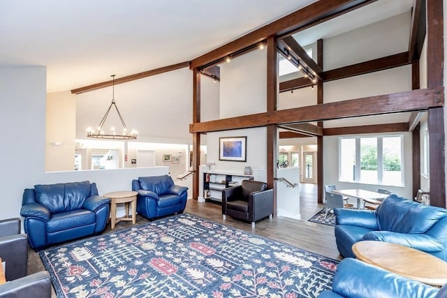 living room with hardwood / wood-style flooring, a high ceiling, and a chandelier