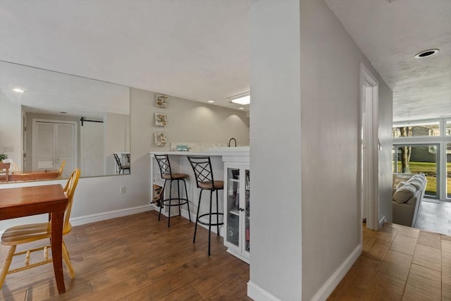 dining room featuring hardwood / wood-style flooring and a barn door