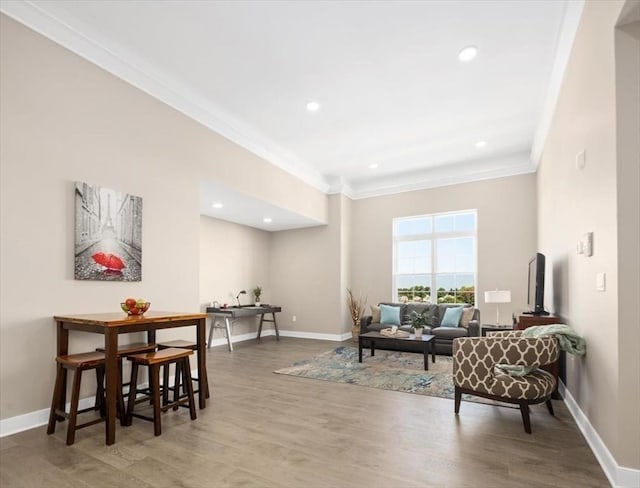 living area featuring wood finished floors, baseboards, ornamental molding, and recessed lighting