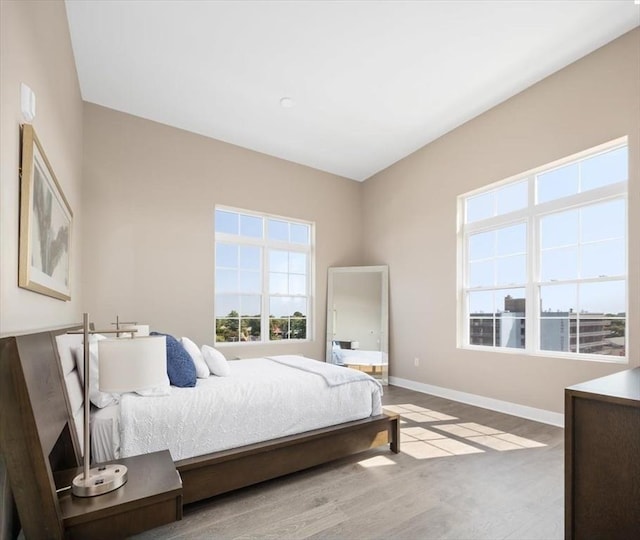 bedroom featuring baseboards and wood finished floors
