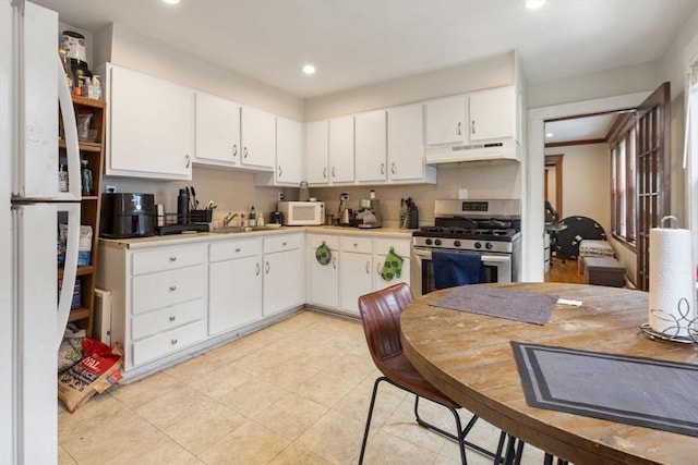 18-20 Presentation Rd, Boston, MA 02135 - kitchen with under cabinet range hood, white appliances, white cabinetry, light countertops, and recessed lighting