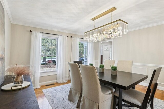 7 Acorn Way, Georgetown, MA 01833 - dining area with light wood-style flooring, ornamental molding, and a chandelier