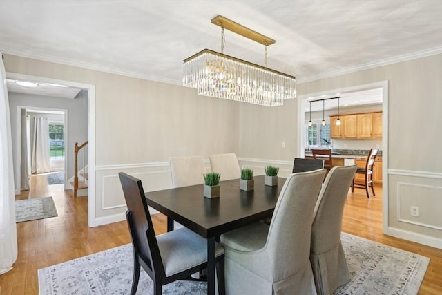 7 Acorn Way, Georgetown, MA 01833 - dining space featuring light wood-type flooring, crown molding, and a chandelier