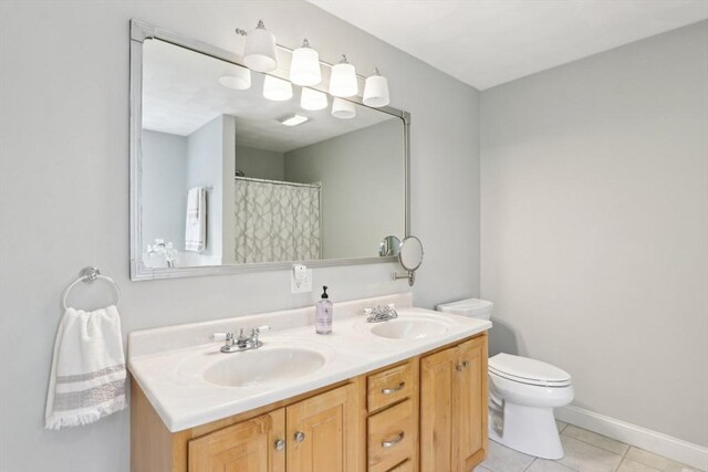 7 Acorn Way, Georgetown, MA 01833 - bathroom with tile patterned floors, toilet, double vanity, baseboards, and a shower with shower curtain