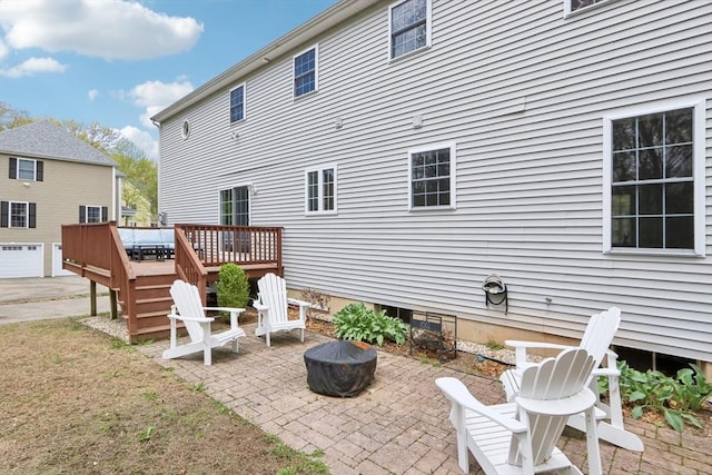 7 Acorn Way, Georgetown, MA 01833 - rear view of property with a wooden deck, a fire pit, and a patio area