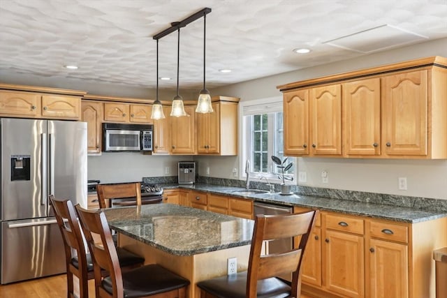 7 Acorn Way, Georgetown, MA 01833 - kitchen featuring appliances with stainless steel finishes, a sink, a kitchen bar, recessed lighting, and a kitchen island