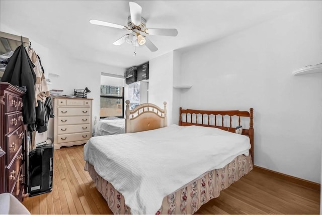 bedroom featuring light hardwood / wood-style floors and ceiling fan