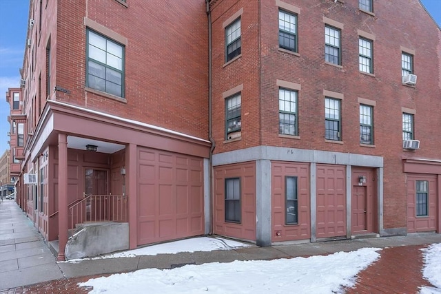 snow covered property featuring cooling unit