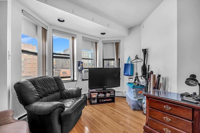 living area with light wood-type flooring and baseboard heating