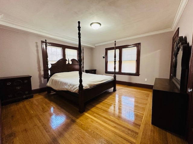 bedroom with wood-type flooring and crown molding