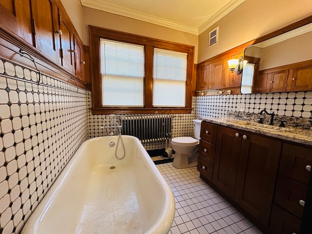 bathroom featuring radiator, tile patterned floors, crown molding, toilet, and vanity