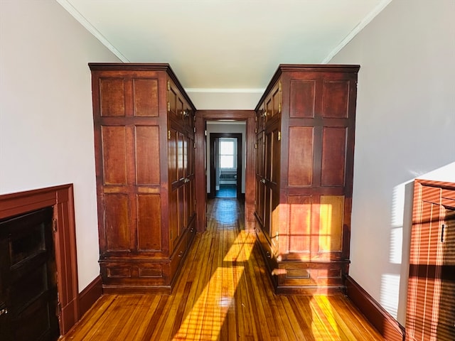 hall with crown molding and hardwood / wood-style floors