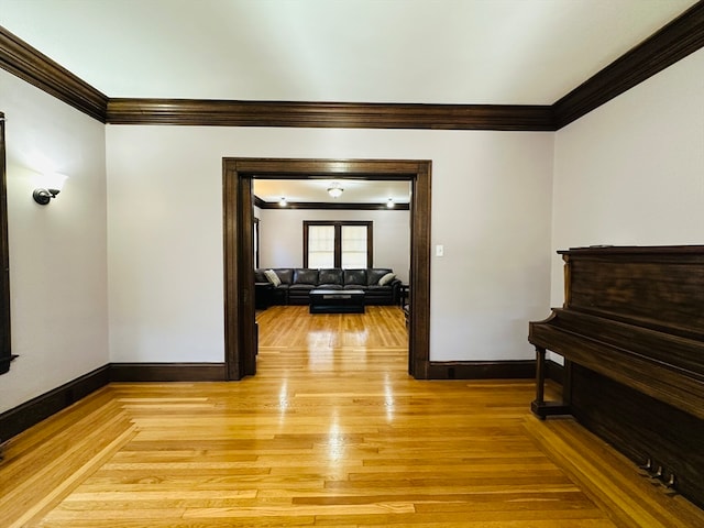 hall featuring light wood-type flooring and crown molding