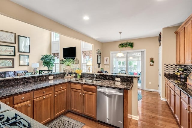 29 Shinglewood, Plymouth, MA 02360 - kitchen with stainless steel dishwasher, a sink, brown cabinetry, light wood finished floors, and recessed lighting