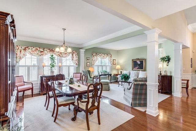 29 Shinglewood, Plymouth, MA 02360 - dining area with light wood finished floors, ornamental molding, decorative columns, a wainscoted wall, and a chandelier