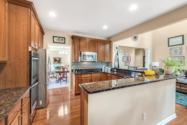 29 Shinglewood, Plymouth, MA 02360 - kitchen with appliances with stainless steel finishes, light wood-style flooring, tasteful backsplash, brown cabinetry, and recessed lighting