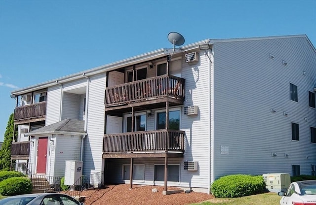 view of building exterior featuring a wall unit AC