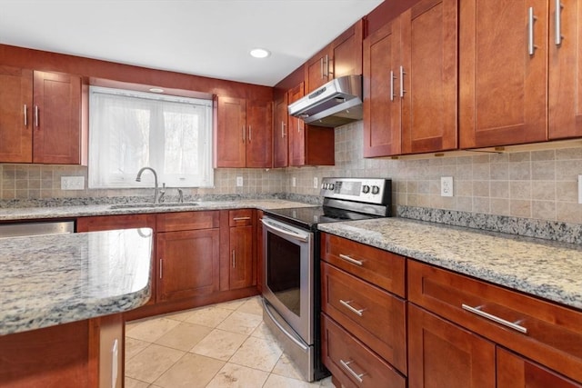 kitchen with appliances with stainless steel finishes, tasteful backsplash, light stone counters, sink, and light tile patterned floors