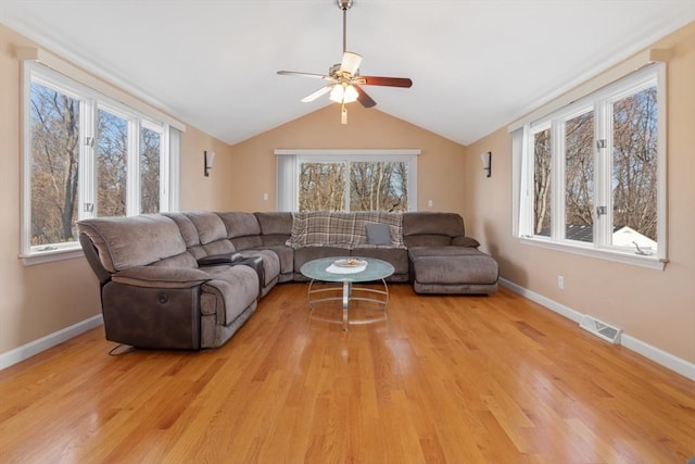 living room featuring ceiling fan, vaulted ceiling, and light wood-type flooring