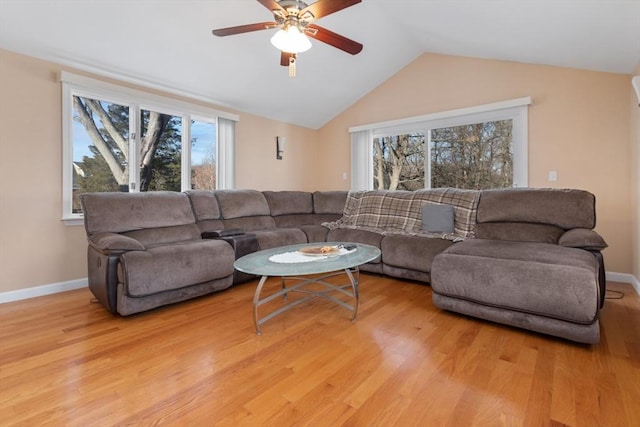 living room with wood-type flooring, vaulted ceiling, plenty of natural light, and ceiling fan