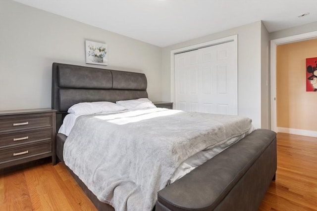 bedroom featuring a closet and light hardwood / wood-style flooring