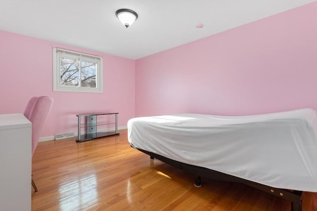 bedroom with hardwood / wood-style floors