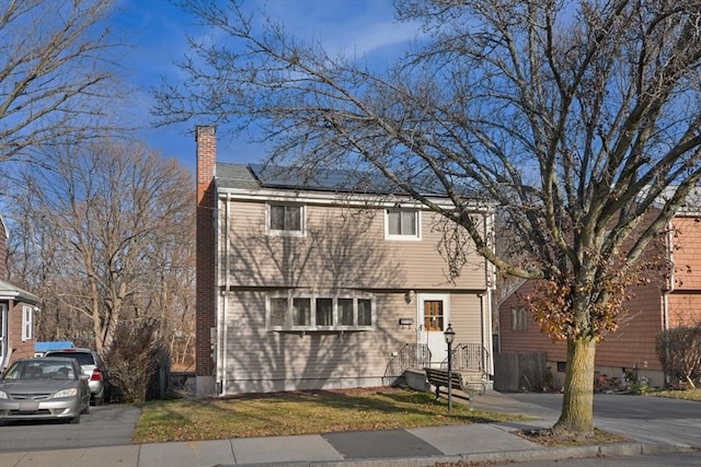 view of front facade with solar panels