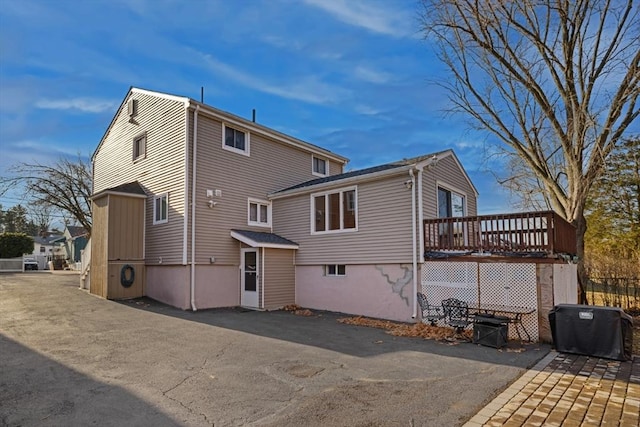 back of house with a wooden deck