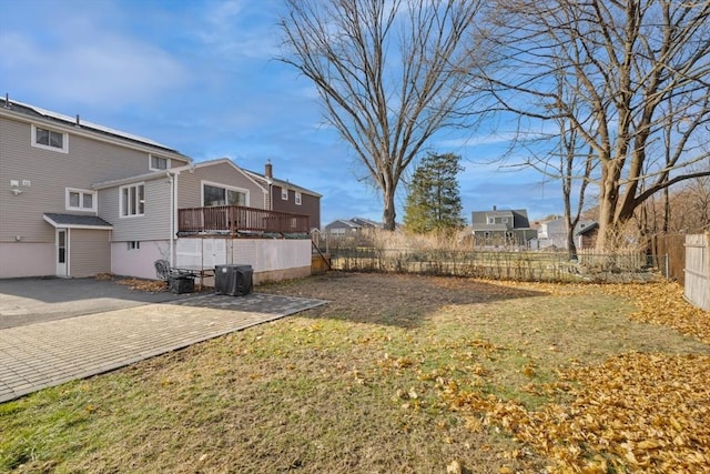 view of yard featuring a patio and a wooden deck