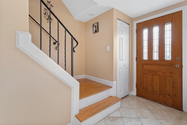 entryway with light tile patterned flooring