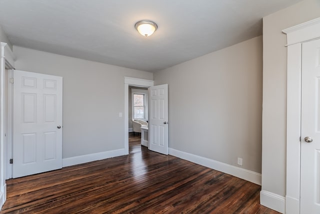 unfurnished bedroom featuring dark hardwood / wood-style floors