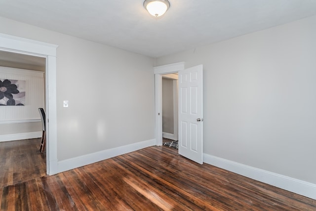 spare room featuring dark wood-type flooring