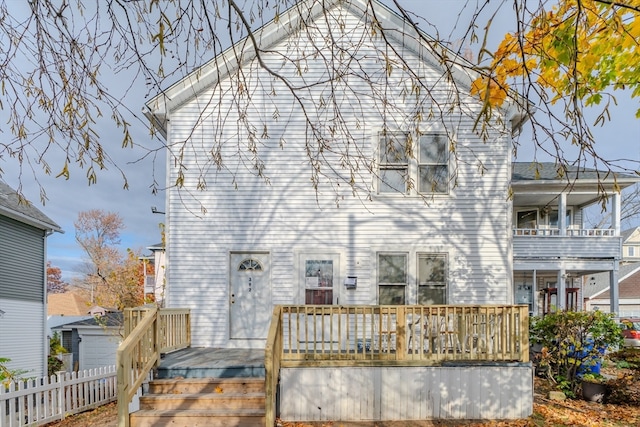 back of house featuring a balcony and a deck