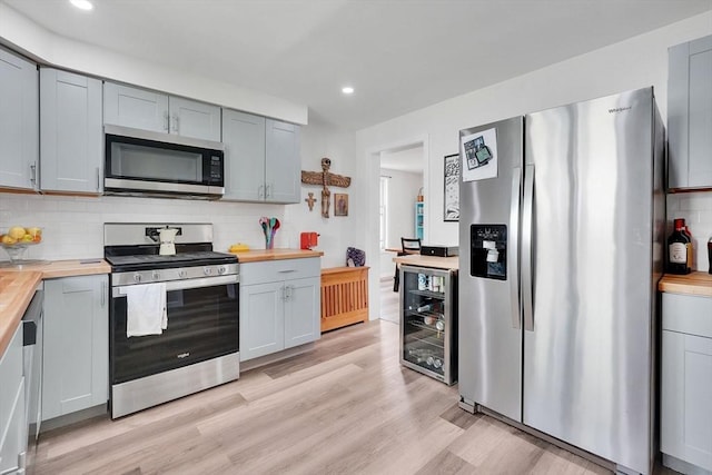 37 Revere St, Springfield, MA 01108 - kitchen featuring stainless steel appliances, wooden counters, beverage cooler, recessed lighting, and decorative backsplash