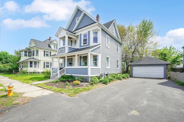 37 Revere St, Springfield, MA 01108 - view of front of house with a porch, an outbuilding, a detached garage, and a chimney