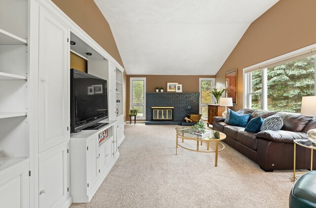 3 Penni Ln, Andover, MA 01810 - living area featuring lofted ceiling, light colored carpet, plenty of natural light, a fireplace, and built in shelves