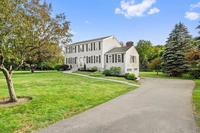 3 Penni Ln, Andover, MA 01810 - colonial inspired home with a chimney, a garage, asphalt driveway, and a front lawn