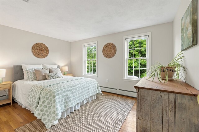 3 Penni Ln, Andover, MA 01810 - bedroom with a baseboard radiator and wood finished floors